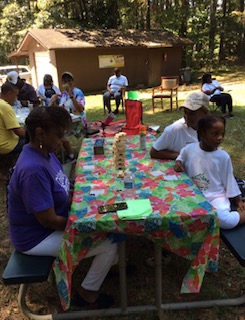 Families enjoying a craft activity together at a Vitality Village outdoor event
