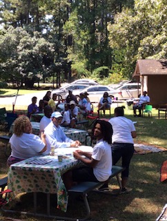 Community members gathered at picnic tables for a Vitality Village event