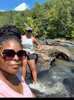 Two village members enjoying a river overlook together
