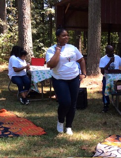 Vitality Village speaker leading a wellness talk at an outdoor gathering